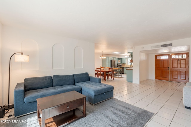 2501 W Calle Paraiso, Tucson, AZ 85745 - living room featuring light tile patterned floors and a chandelier