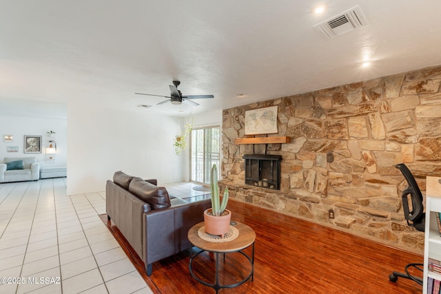 2501 W Calle Paraiso, Tucson, AZ 85745 - living room featuring a fireplace, ceiling fan, and light tile patterned floors