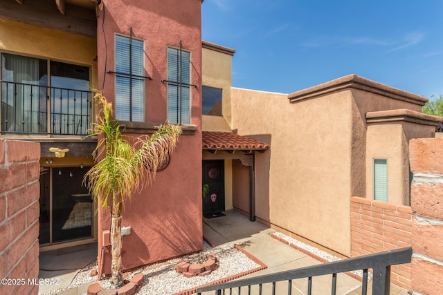 318 N Hasman Dr, Tucson, AZ 85745 - view of exterior entry with stucco siding and a tile roof