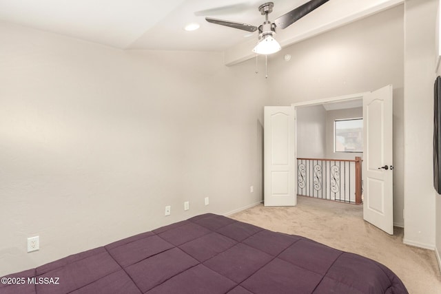 318 N Hasman Dr, Tucson, AZ 85745 - unfurnished bedroom featuring light carpet, a ceiling fan, vaulted ceiling, and baseboards