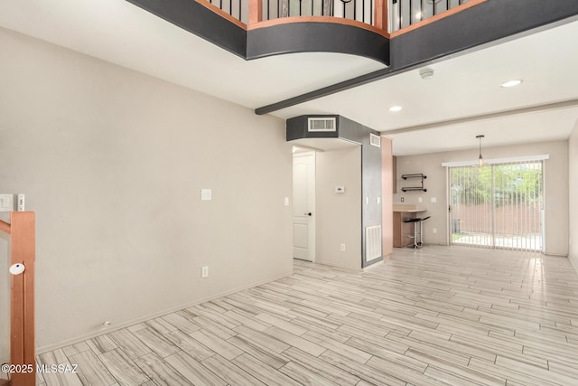 318 N Hasman Dr, Tucson, AZ 85745 - unfurnished living room with light wood-style floors, baseboards, and recessed lighting