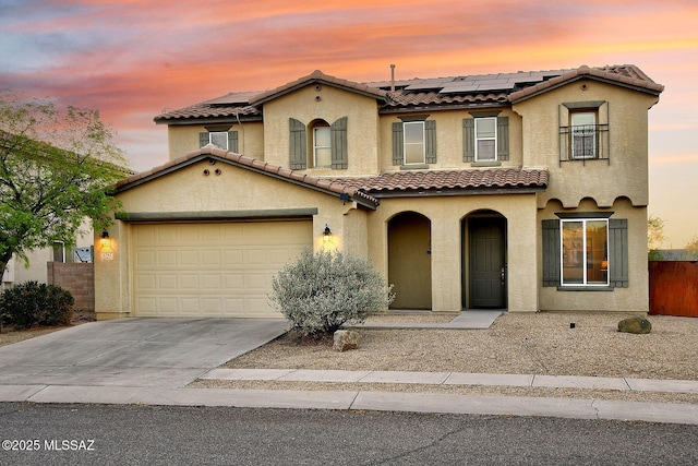 4795 E Silverpuffs Way, Tucson, AZ 85756 - view of front of property featuring stucco siding, a tiled roof, driveway, and solar panels