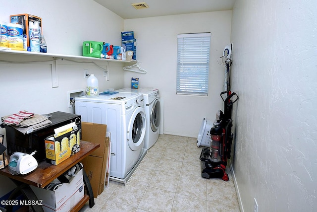 4795 E Silverpuffs Way, Tucson, AZ 85756 - laundry area featuring washer and clothes dryer and light tile patterned floors