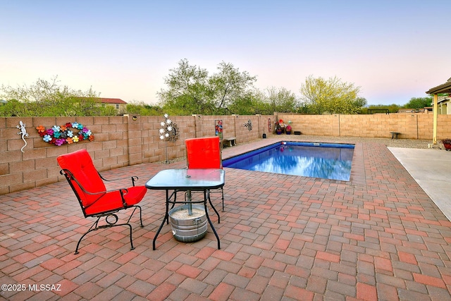 4795 E Silverpuffs Way, Tucson, AZ 85756 - pool at dusk with a patio and a fenced backyard