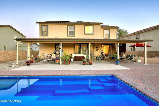 4795 E Silverpuffs Way, Tucson, AZ 85756 - back of house with an outdoor hangout area, stucco siding, a patio area, and a tile roof