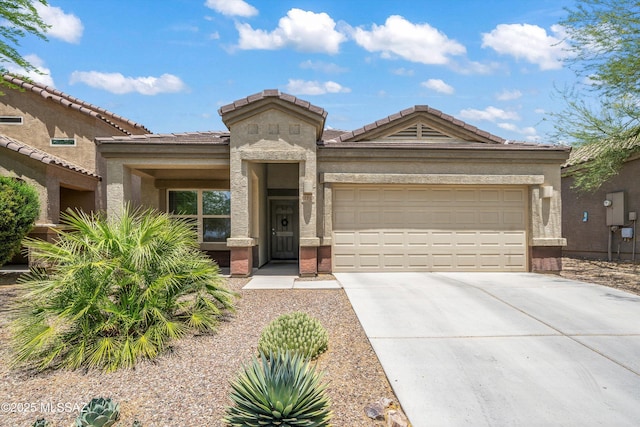 12223 E Becker Dr, Vail, AZ 85641 - view of front of home with concrete driveway, an attached garage, a tiled roof, and stucco siding