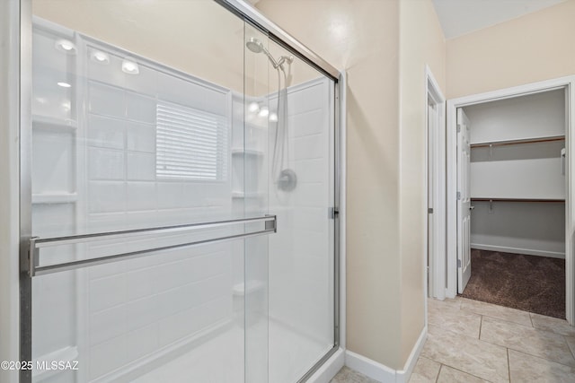 12223 E Becker Dr, Vail, AZ 85641 - full bathroom with a stall shower, a walk in closet, and baseboards