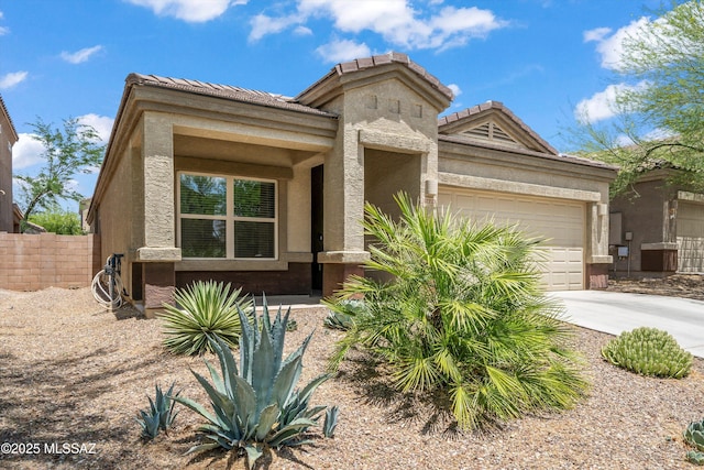 12223 E Becker Dr, Vail, AZ 85641 - view of front facade with an attached garage, concrete driveway, a tiled roof, and stucco siding