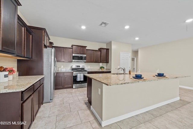 12223 E Becker Dr, Vail, AZ 85641 - kitchen featuring stainless steel appliances, a sink, recessed lighting, dark brown cabinets, and a kitchen island with sink