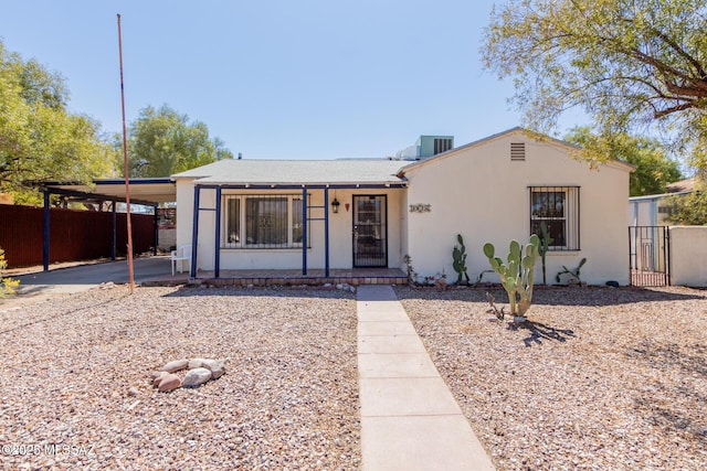 1026 E Mitchell St, Tucson, AZ 85719 - view of front of property with an attached carport, stucco siding, driveway, covered porch, and a gate