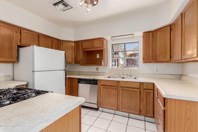 1026 E Mitchell St, Tucson, AZ 85719 - kitchen featuring dishwasher, a sink, freestanding refrigerator, light tile patterned flooring, and light countertops