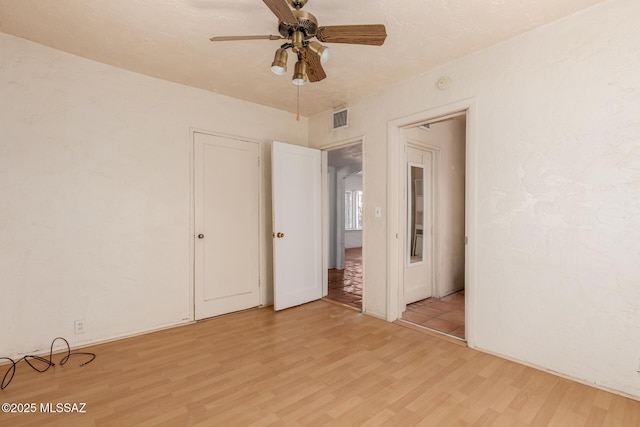 1026 E Mitchell St, Tucson, AZ 85719 - unfurnished bedroom featuring light wood finished floors, a closet, and ceiling fan