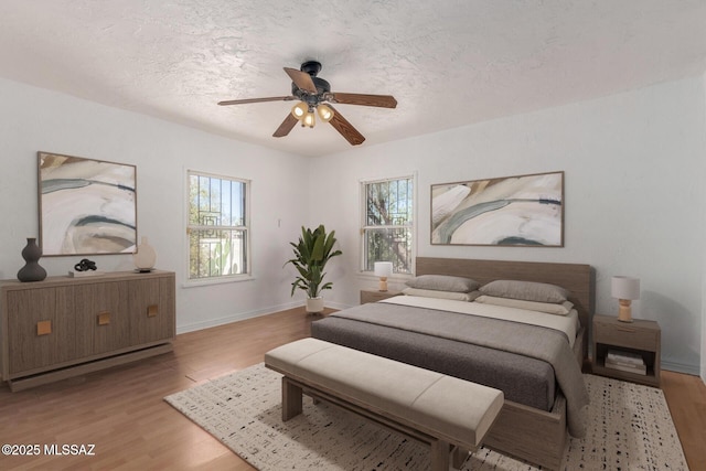 1026 E Mitchell St, Tucson, AZ 85719 - bedroom featuring wood finished floors, baseboards, a ceiling fan, and a textured ceiling