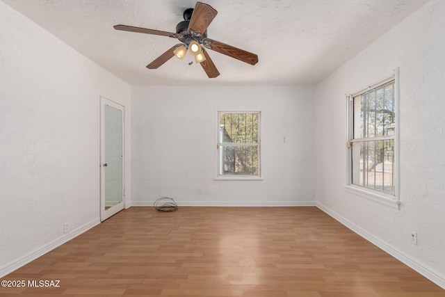 1026 E Mitchell St, Tucson, AZ 85719 - spare room with light wood-style flooring, ceiling fan, and baseboards