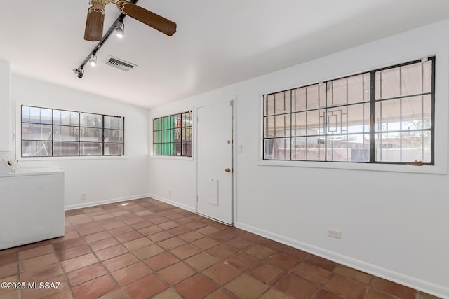 1026 E Mitchell St, Tucson, AZ 85719 - spare room featuring rail lighting, washer and clothes dryer, ceiling fan, and tile patterned floors