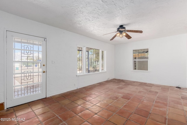 1026 E Mitchell St, Tucson, AZ 85719 - unfurnished room featuring plenty of natural light, ceiling fan, a textured ceiling, and tile patterned flooring