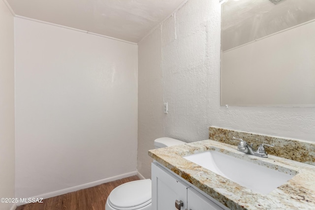 1238 S Camino Seco, Tucson, AZ 85710 - bathroom with wood finished floors, vanity, toilet, and baseboards