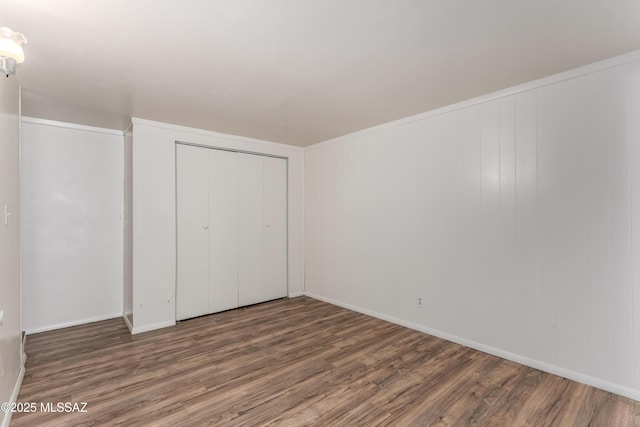1238 S Camino Seco, Tucson, AZ 85710 - unfurnished bedroom with wood finished floors, a closet, and baseboards