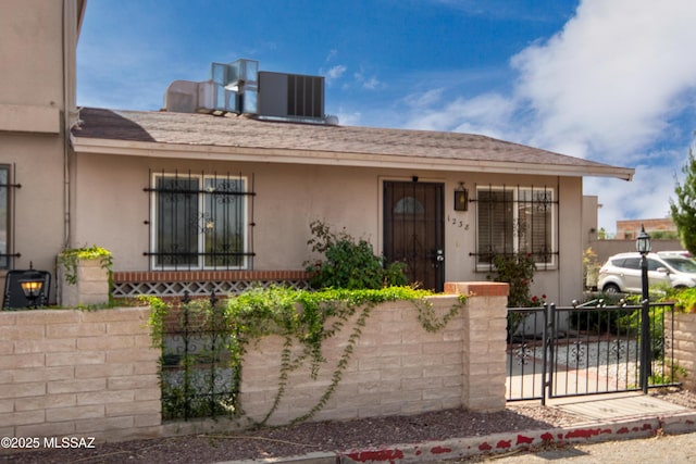 1238 S Camino Seco, Tucson, AZ 85710 - view of front facade with a fenced front yard, a gate, and stucco siding