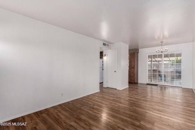1238 S Camino Seco, Tucson, AZ 85710 - spare room featuring a chandelier, wood finished floors, and baseboards