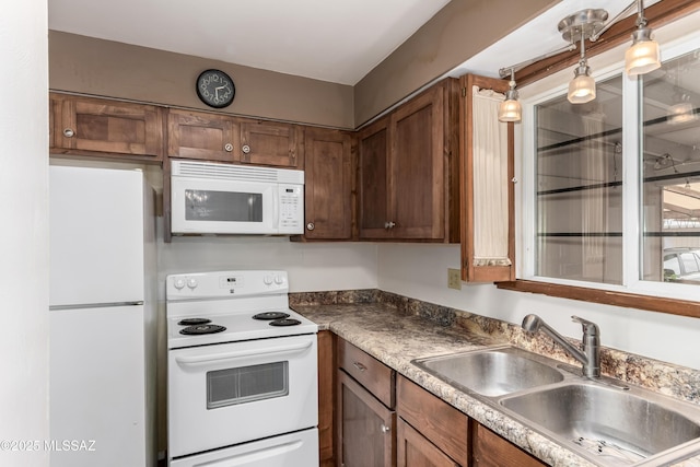 1238 S Camino Seco, Tucson, AZ 85710 - kitchen featuring white appliances, a sink, and decorative light fixtures