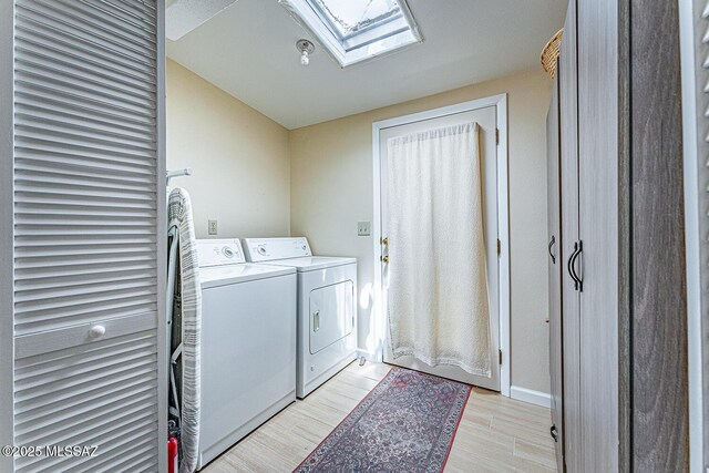 303 S Paseo Cerro Unit A, Green Valley, AZ 85614 - laundry room featuring washing machine and dryer, a skylight, and light wood finished floors