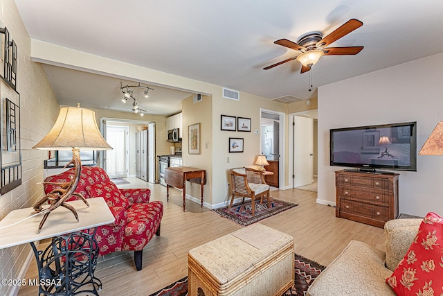 303 S Paseo Cerro Unit A, Green Valley, AZ 85614 - living area with light wood-type flooring, a ceiling fan, and baseboards