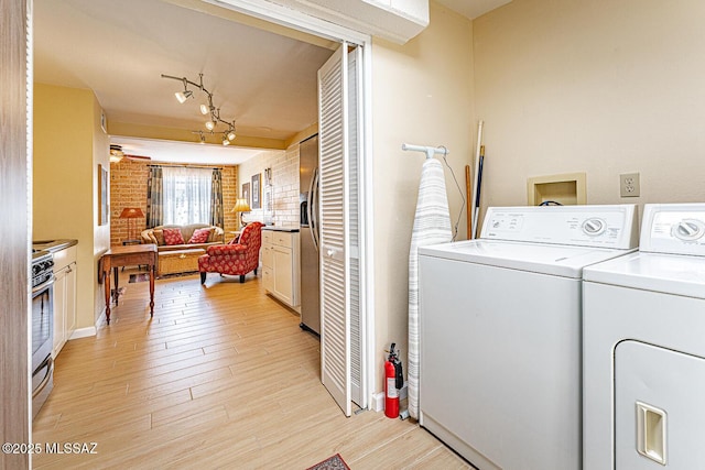 303 S Paseo Cerro Unit A, Green Valley, AZ 85614 - laundry area with separate washer and dryer, light wood-style floors, and rail lighting