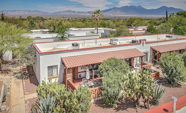 303 S Paseo Cerro Unit A, Green Valley, AZ 85614 - view of front facade with a tile roof, a mountain view, stucco siding, and cooling unit