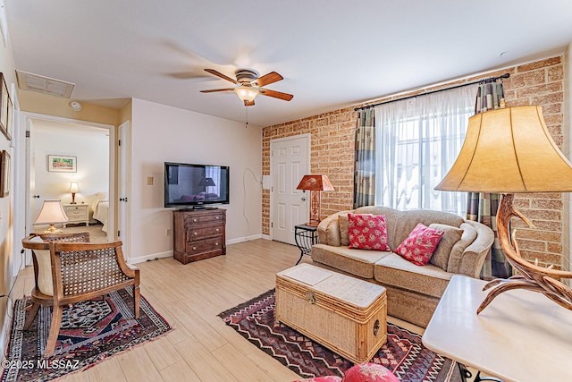 303 S Paseo Cerro Unit A, Green Valley, AZ 85614 - living area with ceiling fan, brick wall, light wood-type flooring, and baseboards