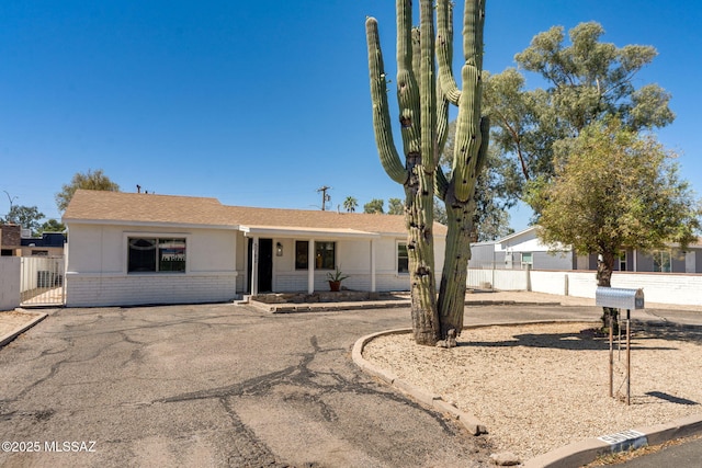 5762 E Helen St, Tucson, AZ 85712 - ranch-style house featuring brick siding and roof with shingles