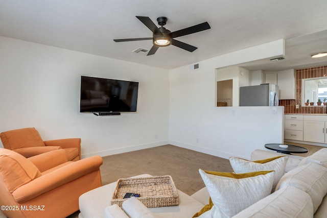 5762 E Helen St, Tucson, AZ 85712 - living area with a ceiling fan, light carpet, and baseboards