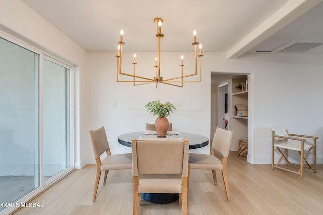5762 E Helen St, Tucson, AZ 85712 - dining area with light wood finished floors, a chandelier, and baseboards