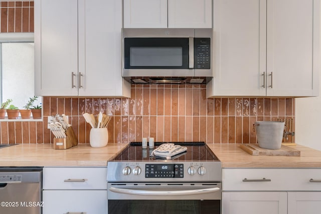 5762 E Helen St, Tucson, AZ 85712 - kitchen featuring appliances with stainless steel finishes, white cabinetry, and decorative backsplash