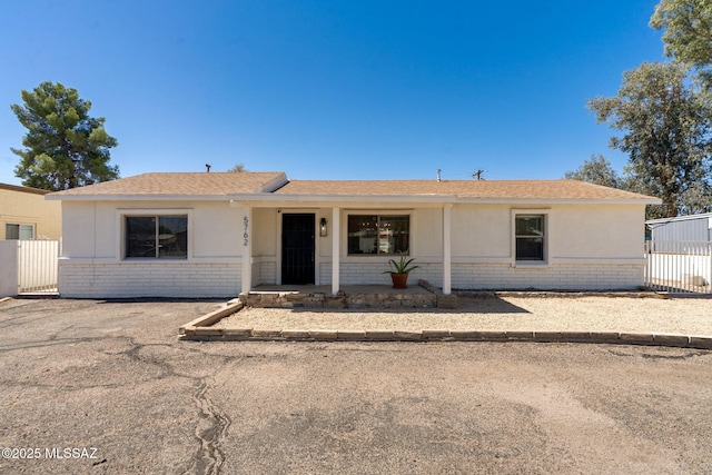 5762 E Helen St, Tucson, AZ 85712 - single story home with brick siding, roof with shingles, and stucco siding