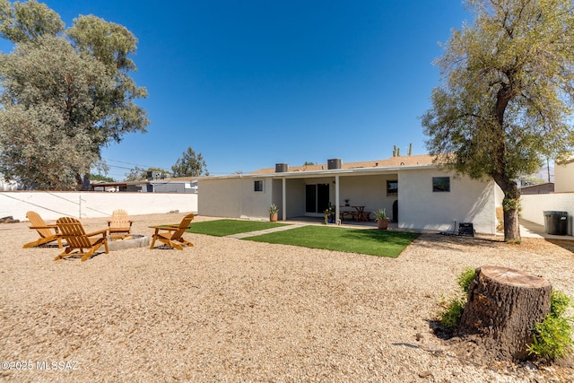 5762 E Helen St, Tucson, AZ 85712 - rear view of house featuring stucco siding, a fire pit, and a patio area