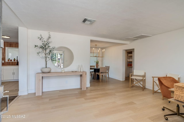 5762 E Helen St, Tucson, AZ 85712 - office area with wood finished floors, a chandelier, and baseboards