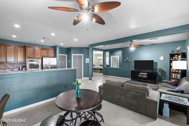 17213 S Mesa Shadows Dr, Vail, AZ 85641 - living room featuring ceiling fan, recessed lighting, baseboards, and finished concrete flooring