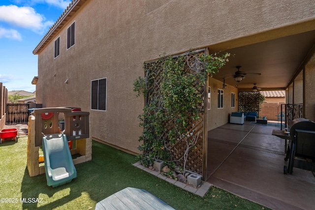 17213 S Mesa Shadows Dr, Vail, AZ 85641 - back of property featuring a playground, a patio area, a ceiling fan, and stucco siding