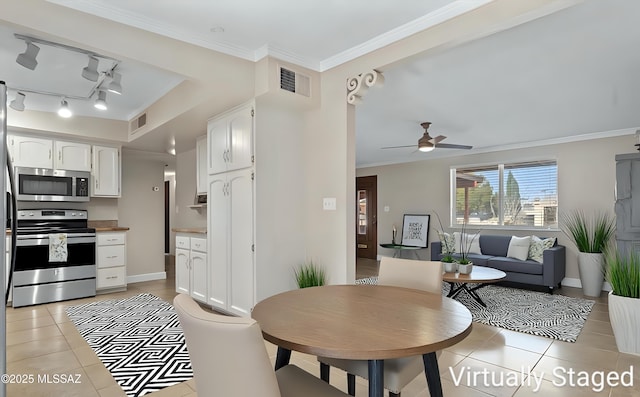 1709 S Avenida Sirio, Tucson, AZ 85710 - dining area featuring light tile patterned floors, a ceiling fan, ornamental molding, baseboards, and track lighting