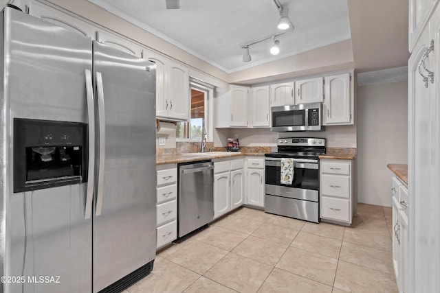 1709 S Avenida Sirio, Tucson, AZ 85710 - kitchen featuring stainless steel appliances, white cabinetry, a sink, crown molding, and light tile patterned floors