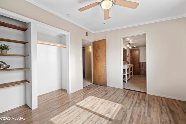 1709 S Avenida Sirio, Tucson, AZ 85710 - unfurnished bedroom with a closet, wood finished floors, ornamental molding, ensuite bath, and a ceiling fan