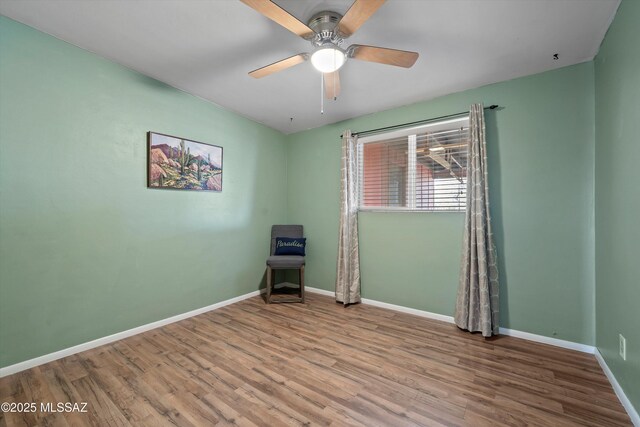 1709 S Avenida Sirio, Tucson, AZ 85710 - unfurnished room with wood finished floors, baseboards, and ceiling fan