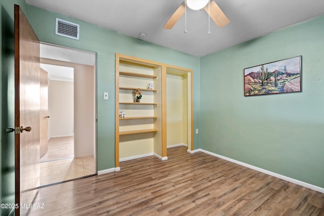 1709 S Avenida Sirio, Tucson, AZ 85710 - unfurnished bedroom featuring wood finished floors, baseboards, and ceiling fan
