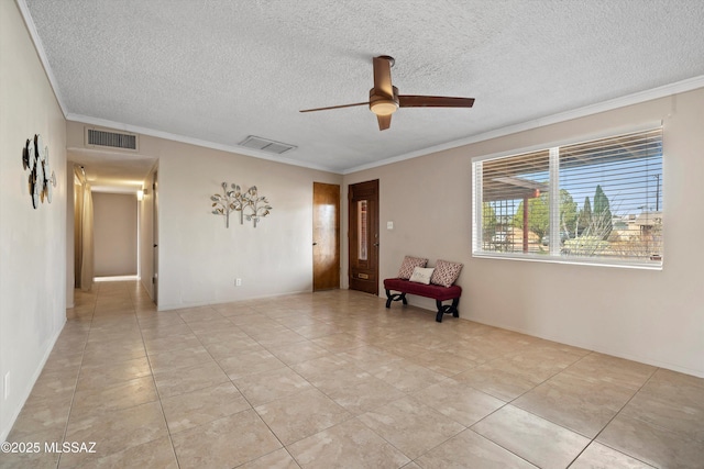 1709 S Avenida Sirio, Tucson, AZ 85710 - spare room featuring ceiling fan, a textured ceiling, crown molding, and light tile patterned floors