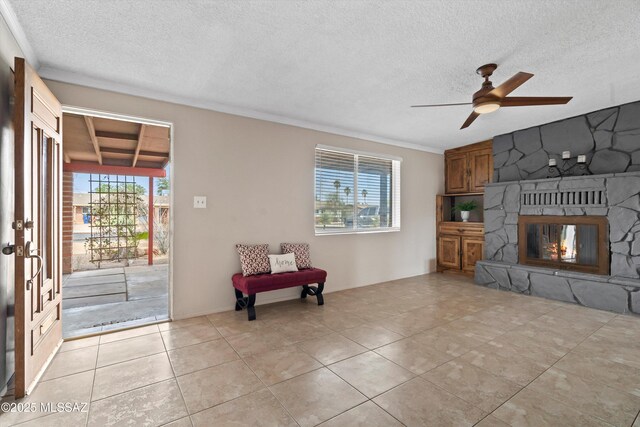 1709 S Avenida Sirio, Tucson, AZ 85710 - living area featuring healthy amount of natural light, a textured ceiling, ceiling fan, ornamental molding, and a fireplace