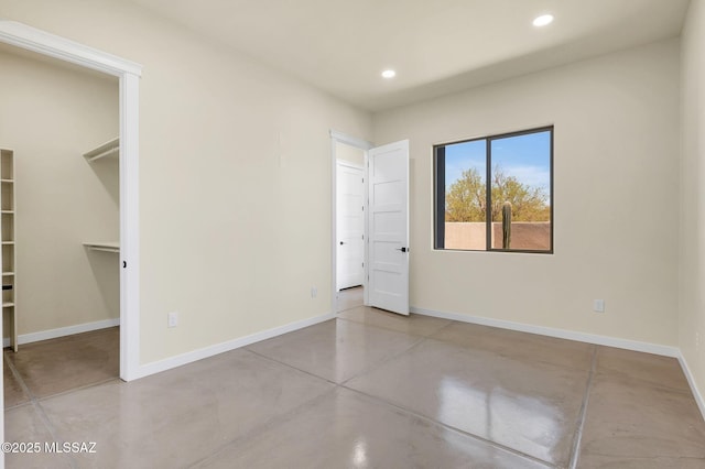 976 W Las Lomitas Rd, Tucson, AZ 85704 - unfurnished bedroom featuring finished concrete floors, recessed lighting, and a walk in closet