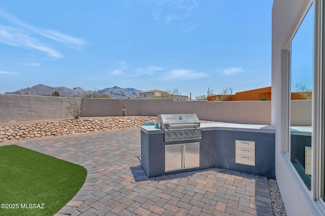 976 W Las Lomitas Rd, Tucson, AZ 85704 - fenced backyard featuring an outdoor kitchen, a patio area, and a mountain view