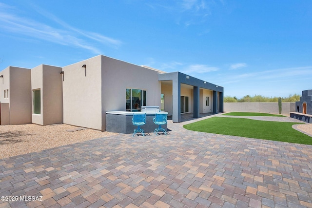 976 W Las Lomitas Rd, Tucson, AZ 85704 - back of property with an outdoor kitchen, a patio, and stucco siding