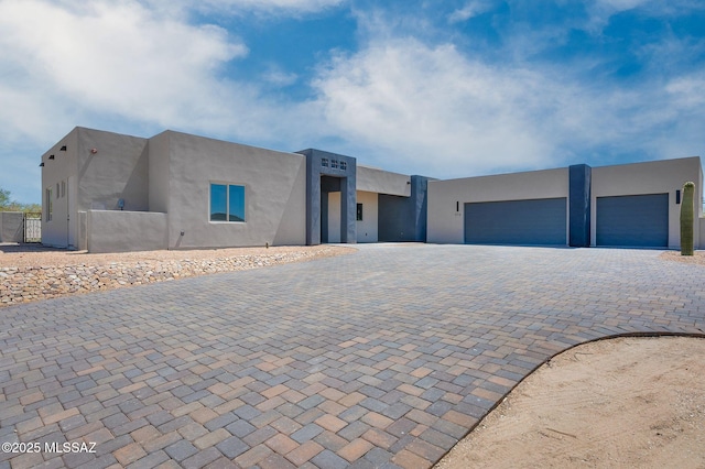 976 W Las Lomitas Rd, Tucson, AZ 85704 - pueblo-style home with decorative driveway, stucco siding, and a garage